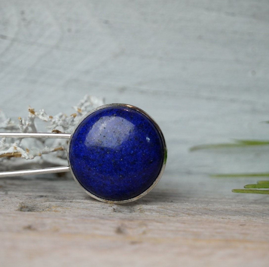 Nahaufnahme des runden königsblauen Lapis Lazuli in silberfarbener Fassung